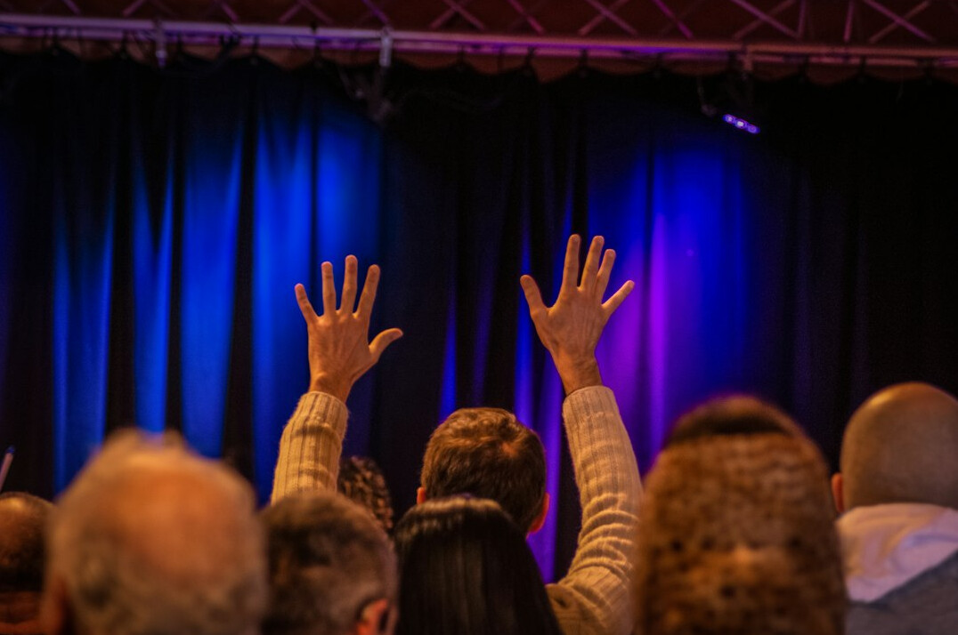 Audience at a conference seen from behind