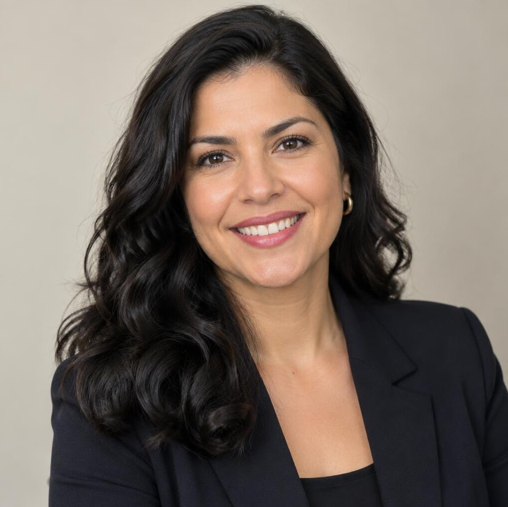 Portrait of a smiling woman in a dark blazer